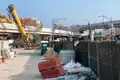 a construction site lies in front of two elevated Chicago L tracks